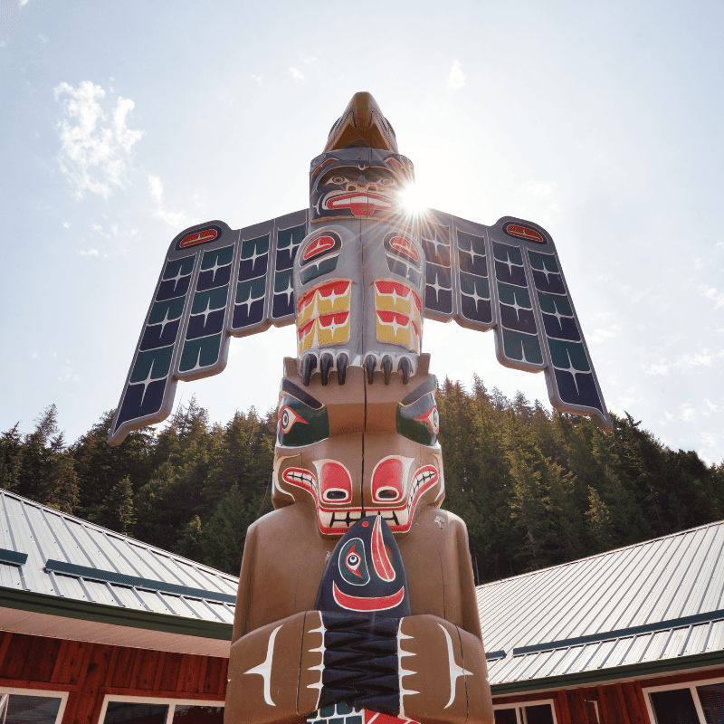 A totem pole stands prominently in the middle of Knight Inlet Lodge, emphasizing Indigenous heritage